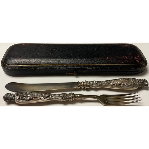 99 - A Victorian silver knife and fork set, the handles in relief with maiden and putto, mid 19th century... 