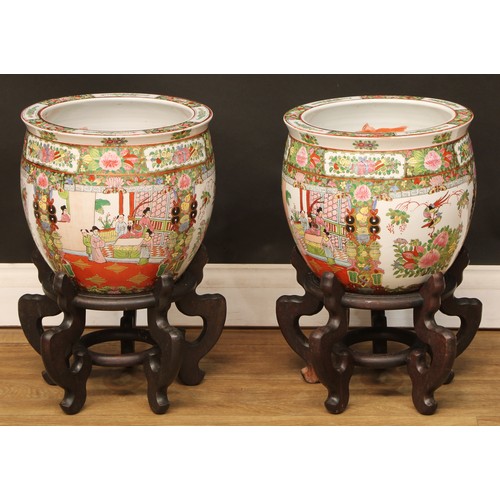 121 - A pair of Chinese famille rose fish bowls, hardwood stands, 48.5cm high on stand, 31.5cm diameter (2... 