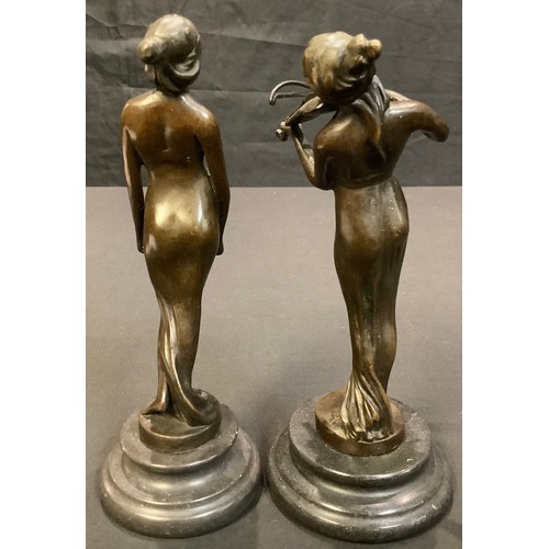 161 - A near pair of dark patinated bronzed figures, of a lady playing a violin, her companion holding a t... 