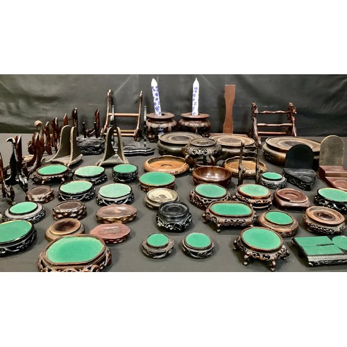 290 - A collection of Oriental hard and soft wood stands, some pierced, various sizes and styles