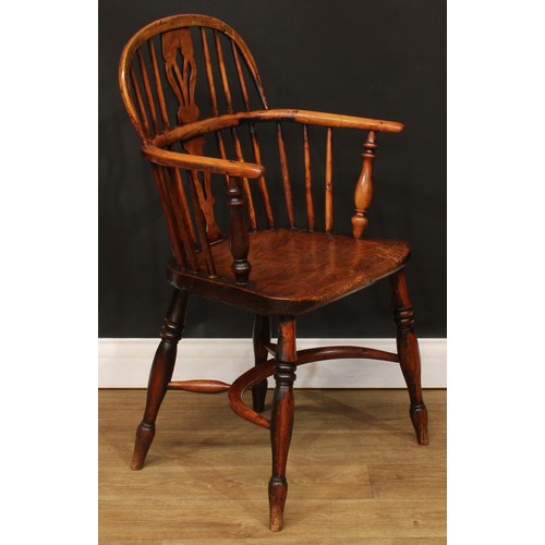 102 - A 19th century Windsor elbow chair, low hoop back, shaped and pierced splat, turned arm posts, saddl... 