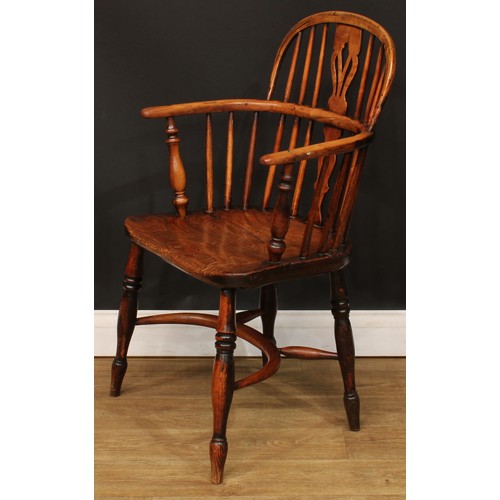 102 - A 19th century Windsor elbow chair, low hoop back, shaped and pierced splat, turned arm posts, saddl... 