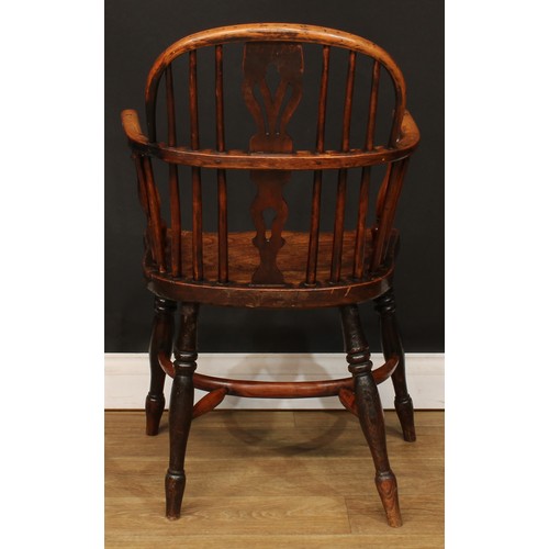 102 - A 19th century Windsor elbow chair, low hoop back, shaped and pierced splat, turned arm posts, saddl... 