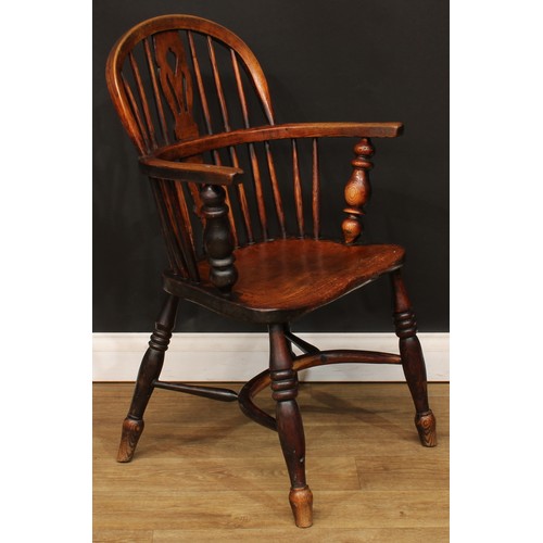 104 - A 19th century Windsor elbow chair, low hoop back, shaped and pierced splat, turned arm posts, saddl... 