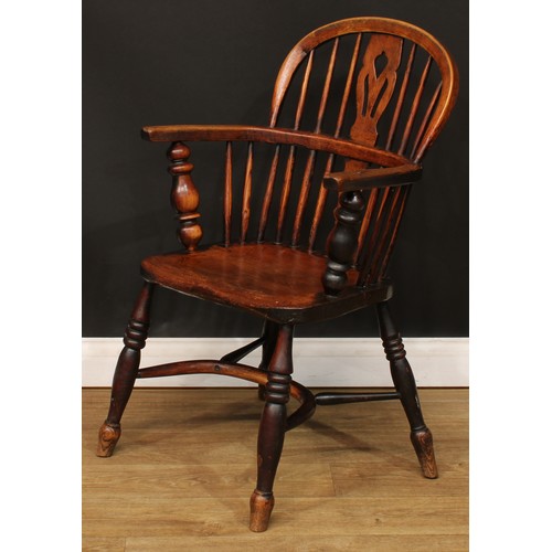 104 - A 19th century Windsor elbow chair, low hoop back, shaped and pierced splat, turned arm posts, saddl... 