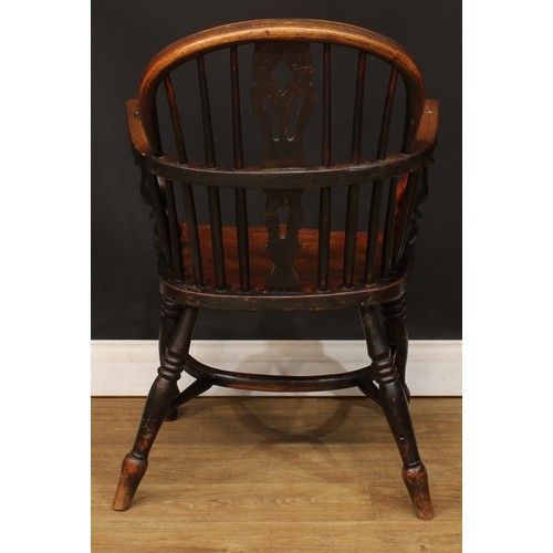 104 - A 19th century Windsor elbow chair, low hoop back, shaped and pierced splat, turned arm posts, saddl... 