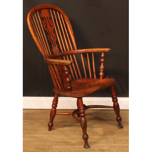 106 - A 19th century Windsor elbow chair, hoop back, shaped and pierced splat, one-piece mid-rail, turned ... 