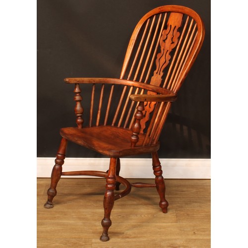 106 - A 19th century Windsor elbow chair, hoop back, shaped and pierced splat, one-piece mid-rail, turned ... 