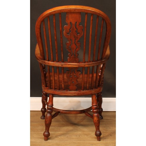 106 - A 19th century Windsor elbow chair, hoop back, shaped and pierced splat, one-piece mid-rail, turned ... 