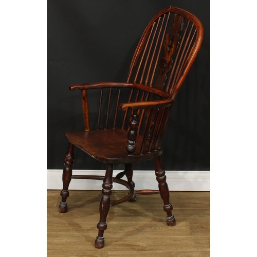 110 - A 19th century yew and elm primary Windsor elbow chair, 108cm high, 57cm wide, the seat 41cm wide an... 