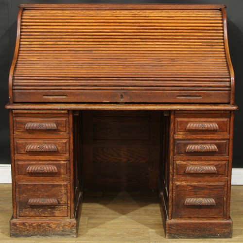 111 - An early 20th century oak tambour roll top desk, 129cm high, 127cm wide, 81.5cm deep