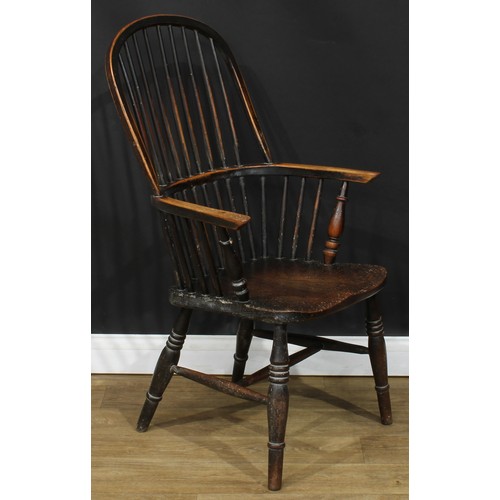 112 - A 19th century beech and elm stick back Windsor elbow chair, hoop back, one-piece mid-rail, turned a... 