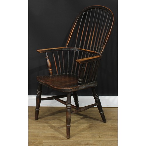 112 - A 19th century beech and elm stick back Windsor elbow chair, hoop back, one-piece mid-rail, turned a... 