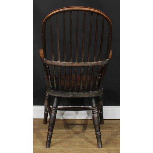 112 - A 19th century beech and elm stick back Windsor elbow chair, hoop back, one-piece mid-rail, turned a... 