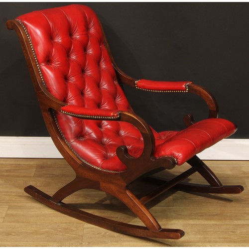 118 - A George/William IV style library rocking chair, stuffed-over deep-button upholstery with studded bo... 