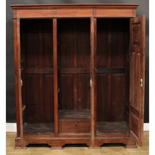 119 - An 18th century style black walnut armoire or wardrobe, outswept cornice above three panel doors, th... 