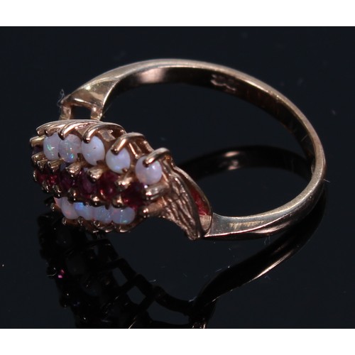 140A - A 9ct gold ring, set with three bands of polished opal and faceted ruby stones, size L, marked 375, ... 