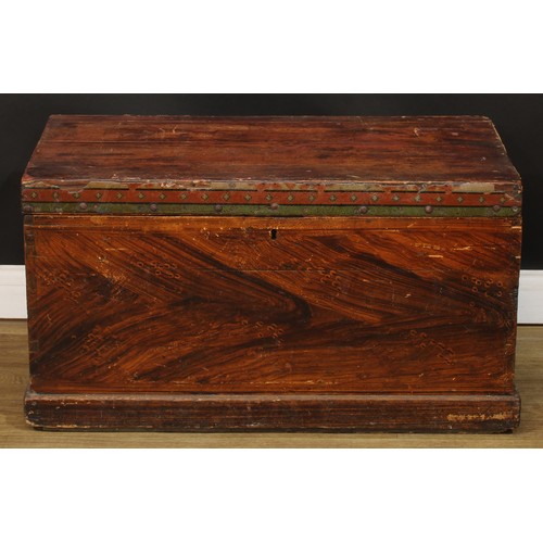 716 - A pine chest, hinged cover enclosing a till, the sides scumbled, carry handles to sides, paper label... 