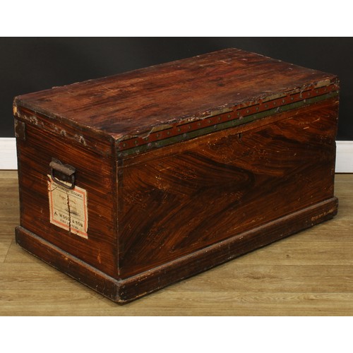 716 - A pine chest, hinged cover enclosing a till, the sides scumbled, carry handles to sides, paper label... 