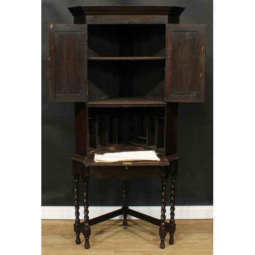 114A - An unusual Jacobean Revival oak secretaire cabinet on stand, for the corner, 183cm high, 86cm wide, ... 