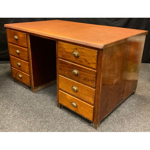 42 - An early 20th century oak pedestal desk, faux tan leather top, each pedestal with four drawers, bras... 