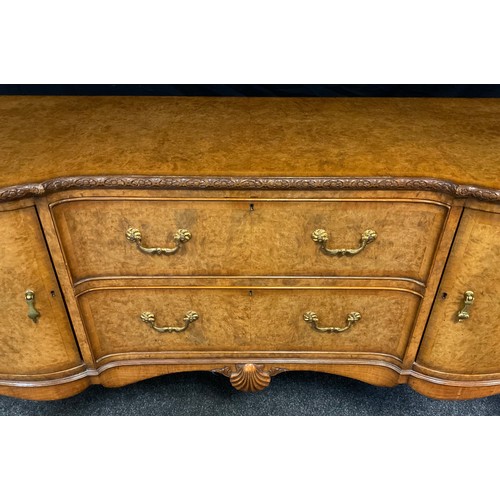 58 - A mid 20th century burr walnut, inverted breakfront sideboard, made for Hille of London, finely figu... 