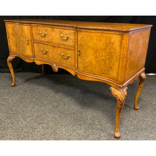 58 - A mid 20th century burr walnut, inverted breakfront sideboard, made for Hille of London, finely figu... 