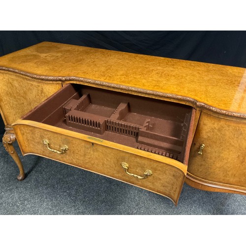 58 - A mid 20th century burr walnut, inverted breakfront sideboard, made for Hille of London, finely figu... 