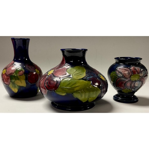 22 - A Moorcroft Clematis pattern compressed ovoid vase, 11cm, impressed marks, monogrammed; a similar bo... 