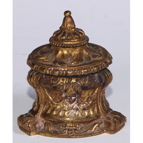 26 - A 19thC ormolu inkwell, cast overall with masks and swags, scroll feet, 8.5cm high, c.1870 (lacks gl... 