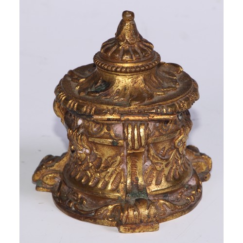 26 - A 19thC ormolu inkwell, cast overall with masks and swags, scroll feet, 8.5cm high, c.1870 (lacks gl... 