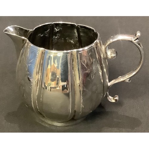 31 - A Victorian Aesthetic Movement silver pumpkin shaped cream jug, chased with flowers, Sheffield 1886,... 