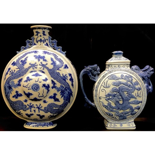 51 - A Chinese blue and white moon flask, painted with dragons chasing the flaming pearl, dragon handles,... 