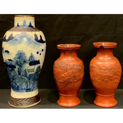 52 - A Chinese blue and white crackle glaze vase, 22cm high; a pair of Chinese dragon vases (faults) [3]