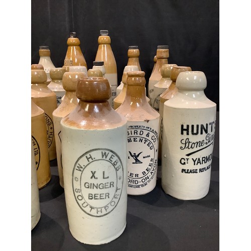 61 - Advertising Bottles - stoneware ginger beer bottles including W. E. Burrows, Derby; W.Simpson, Walkd... 