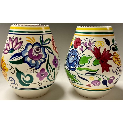 64 - A pair of Poole ovoid vases, hand painted with large flower heads in colourful shades, 21cm, printed... 