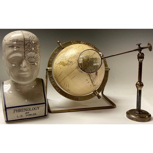 311 - A replica phrenology bust, after L.N. Fowler, 29cm high; an articulated library magnifying glass; a ... 