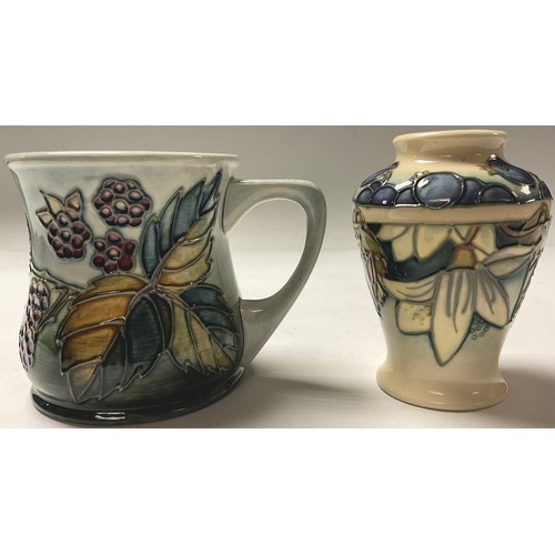 380 - A Moorcroft Bramble pattern mug, 9cm, impressed marks, date code for 1993; a Moorcroft Blueberry pat... 