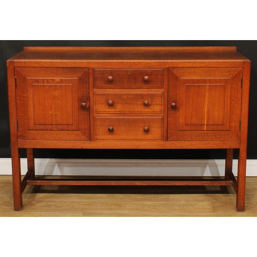 101 - An Arts & Crafts oak sideboard, by Heal's (Heals), rectangular top with shallow half gallery above t... 