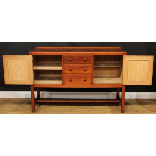 101 - An Arts & Crafts oak sideboard, by Heal's (Heals), rectangular top with shallow half gallery above t... 