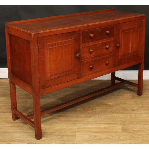 101 - An Arts & Crafts oak sideboard, by Heal's (Heals), rectangular top with shallow half gallery above t... 