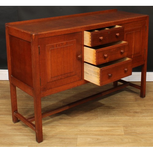 101 - An Arts & Crafts oak sideboard, by Heal's (Heals), rectangular top with shallow half gallery above t... 