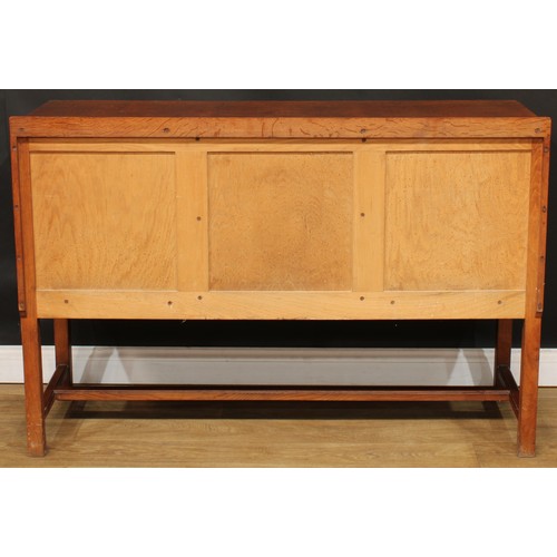 101 - An Arts & Crafts oak sideboard, by Heal's (Heals), rectangular top with shallow half gallery above t... 