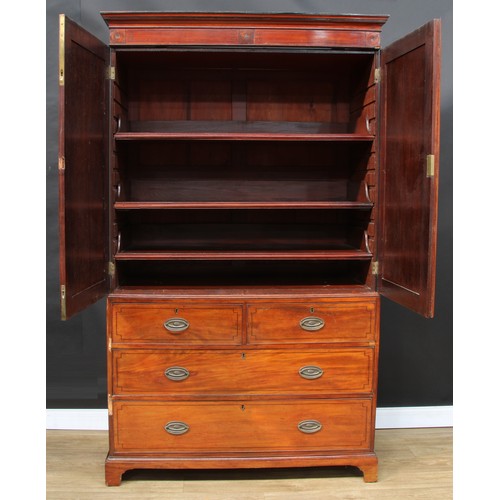 120 - A 19th century mahogany linen press, outswept cornice above a pair of panel doors enclosing three sl... 