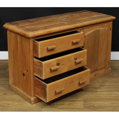 205 - A Victorian farmhouse pine low dresser, rectangular top above three short drawers neighboured by a p... 