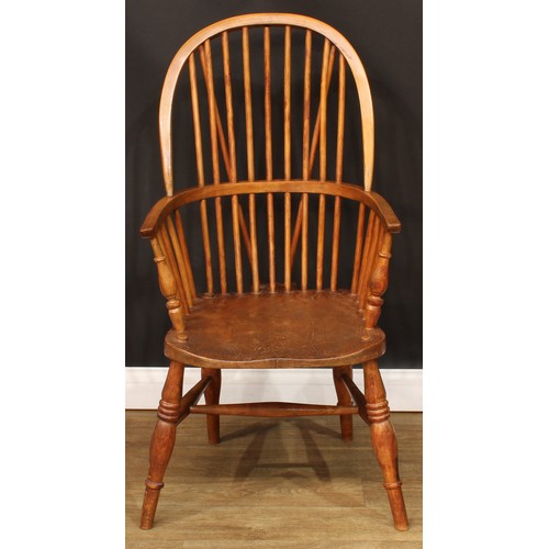 208 - A beech and elm Windsor elbow chair, hoop back, one-piece mid-rail, turned arm posts, saddle seat, t... 