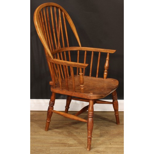 208 - A beech and elm Windsor elbow chair, hoop back, one-piece mid-rail, turned arm posts, saddle seat, t... 