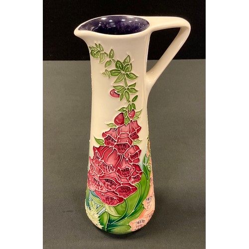 45 - A Moorcroft Amber Wood jug, designed by Rachel Bishop, tune lined with  foxgloves on an ivory ground... 