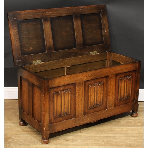 578 - An oak blanket chest, applied with linenfolds, 54cm high, 100.5cm wide, 43.5cm deep