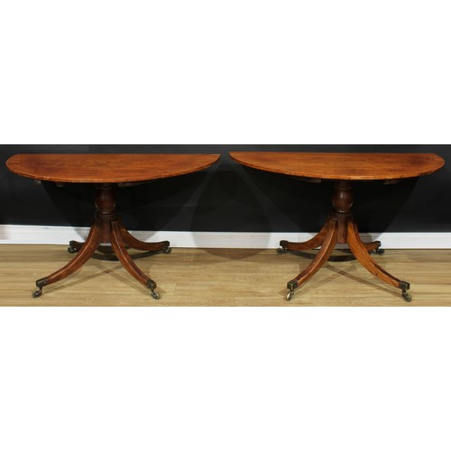 579 - A pair of Regency mahogany demilune pedestal tables, formerly the end sections of a multiple pillar ... 